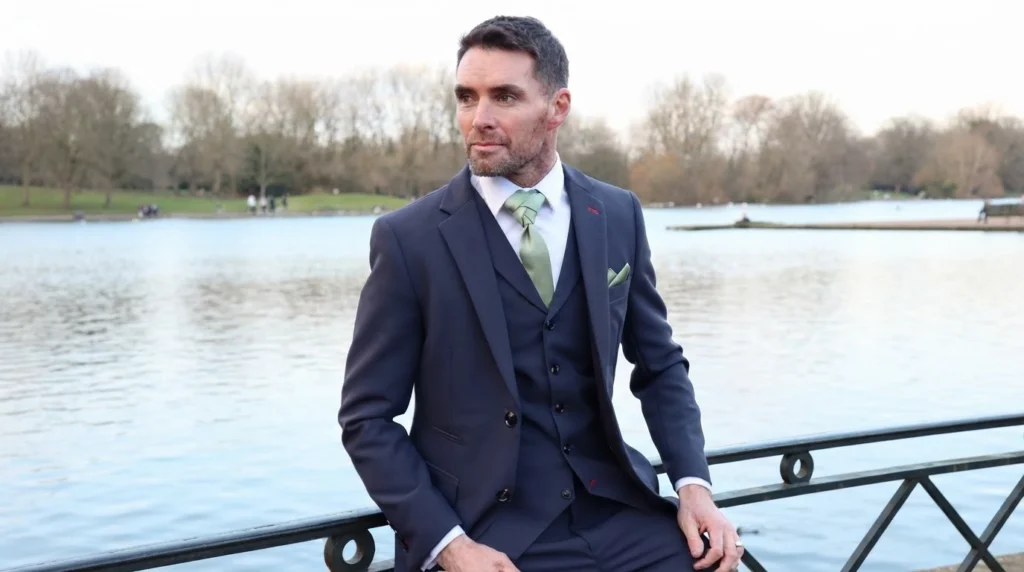 Man in suit by a lake