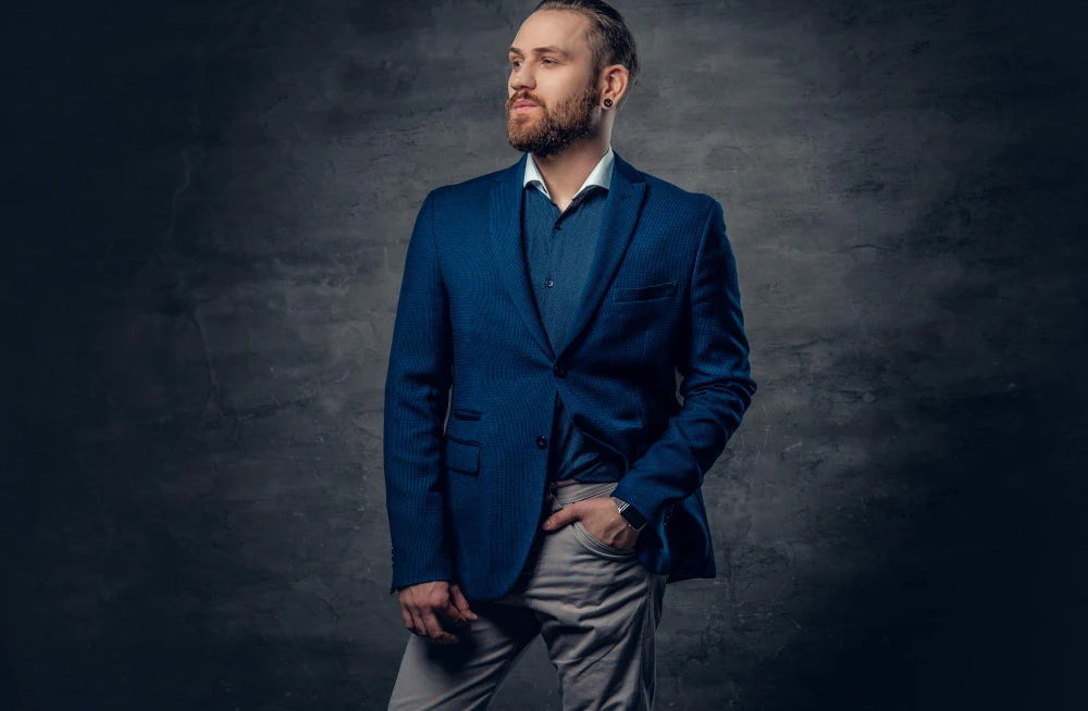 Man in a Navy Blue suit standing confidently