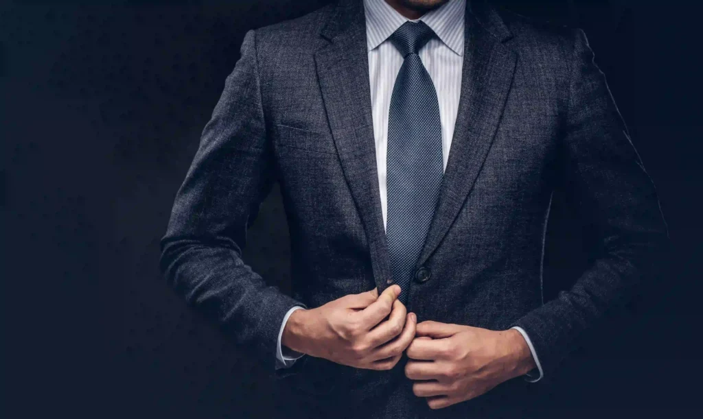Man adjusting suit jacket