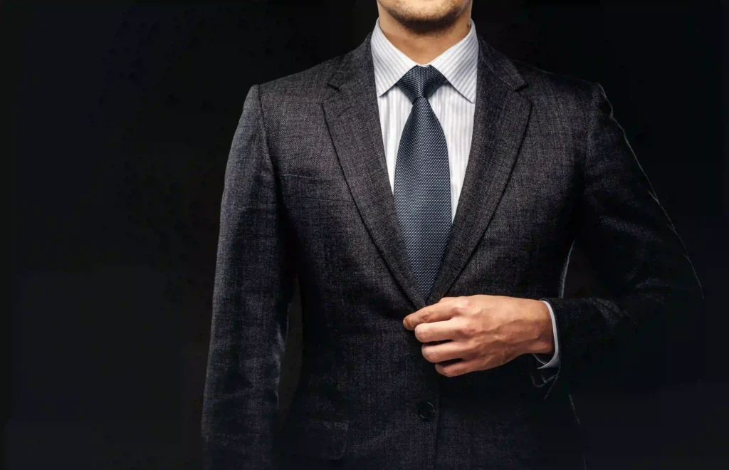 Man in suit adjusting his tie