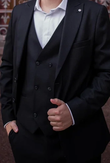 A single-breasted suit features a jacket with a single column of buttons and a narrow overlap. It is the most versatile suit style, suitable for both formal and casual settings. Available in various fits and fabrics, it offers a timeless and modern look for any occasion.