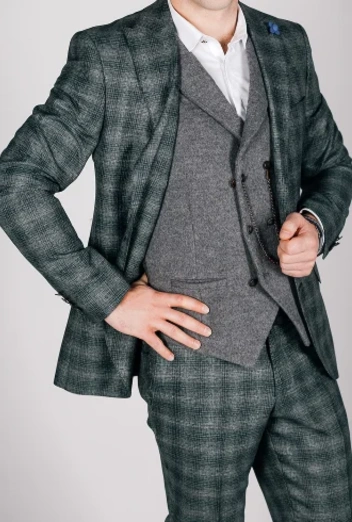 A single-breasted suit features a jacket with a single column of buttons and a narrow overlap. It is the most versatile suit style, suitable for both formal and casual settings. Available in various fits and fabrics, it offers a timeless and modern look for any occasion.